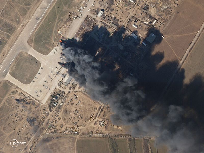 A satellite image shows a plume of smoke rising from the Kherson International Airport on Tuesday, March 15. When zoomed in, the images show a number of helicopters on fire.