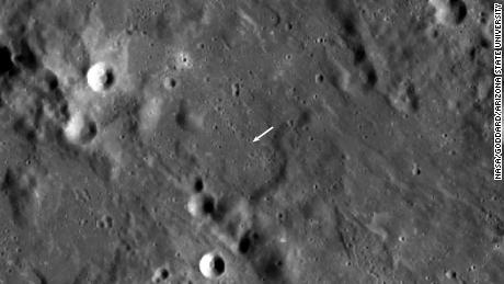 A nova cratera é menor que a outra cratera e não é visível nesta vista, mas sua localização é indicada pela seta branca. 
